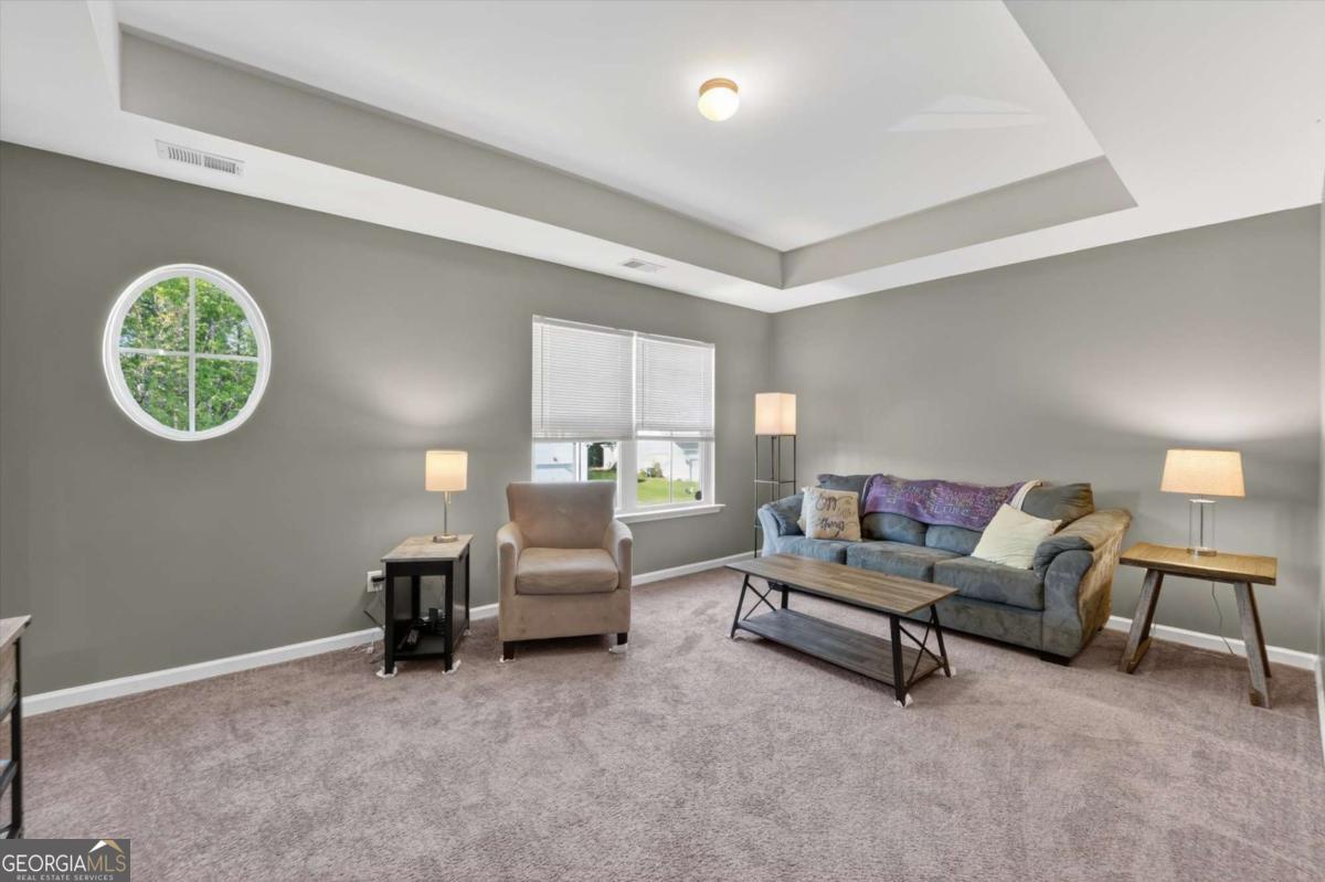 369 Waybridge Way Richmond Hill, GA 31324 - Photo 29 of 40 a living room with furniture and a lamp