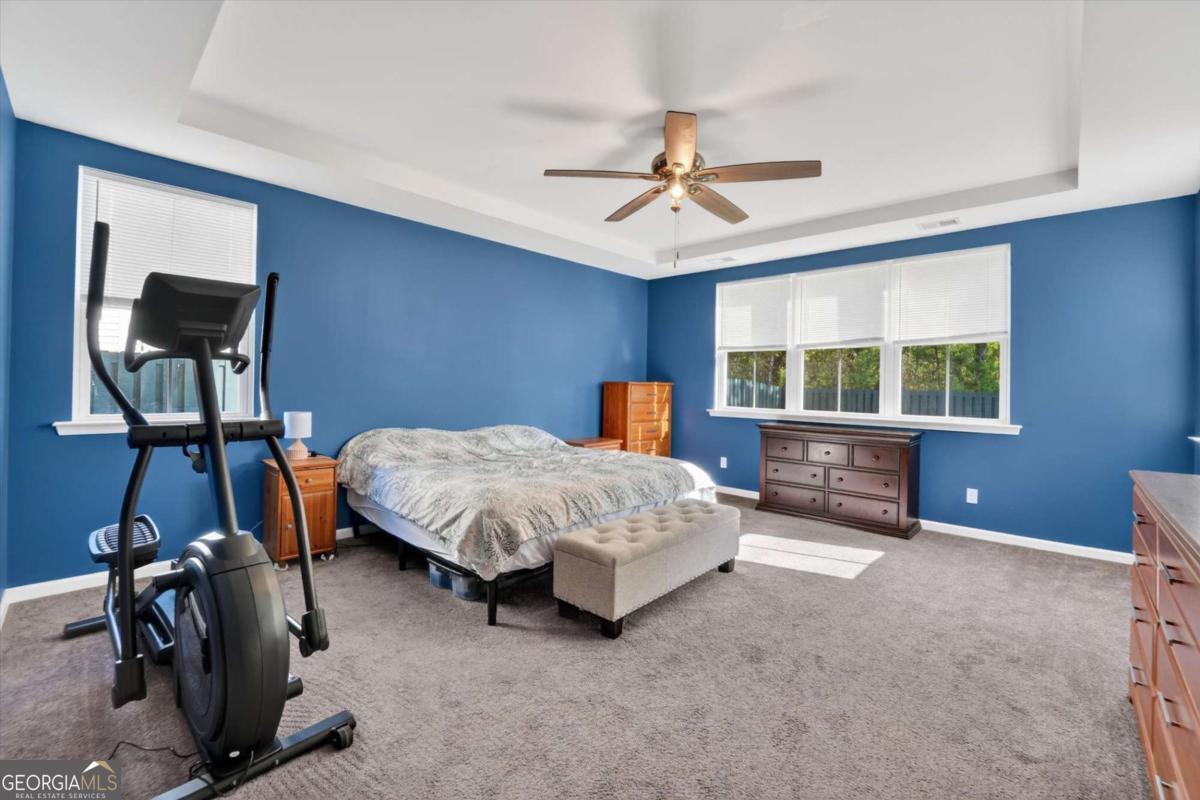 369 Waybridge Way Richmond Hill, GA 31324 - Photo 32 of 40 a bedroom with a bed a table and chair