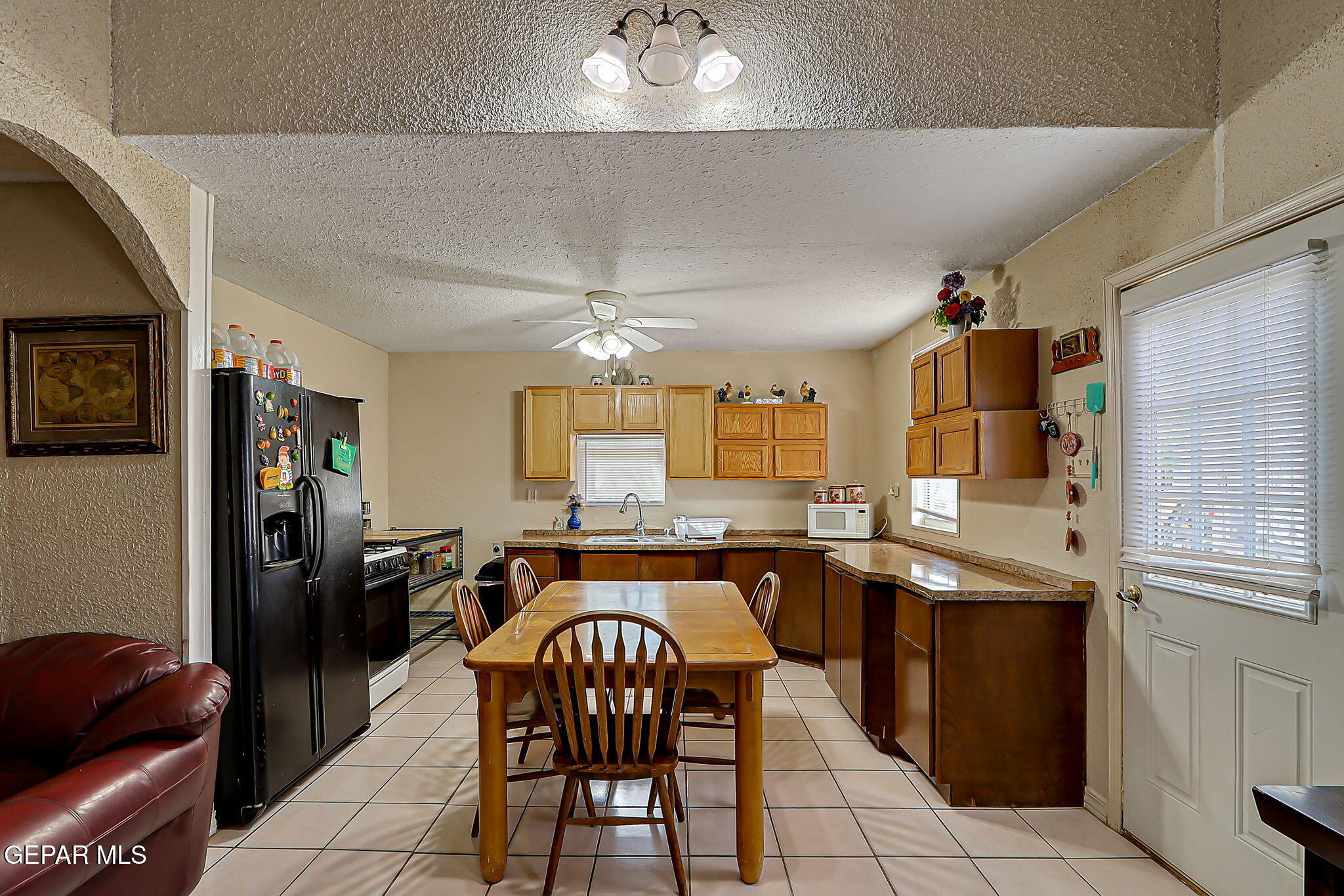 19210 Rancho Road Tornillo, TX 79853 - Photo 4 of 14 a kitchen with stainless steel appliances a table chairs and chandelier