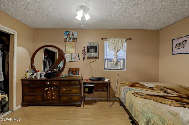 a bed room with a bed and a dresser