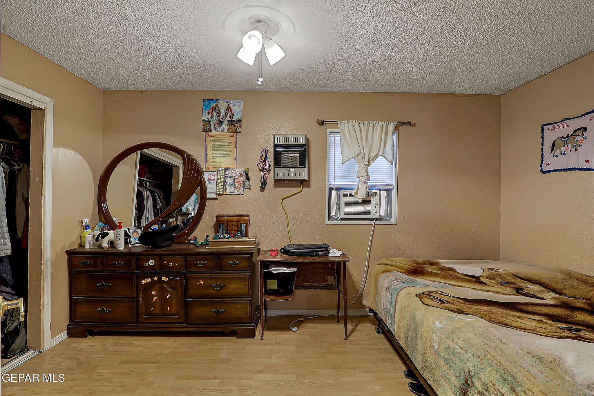 19210 Rancho Road Tornillo, TX 79853 - Photo 7 of 14 a bed room with a bed and a dresser