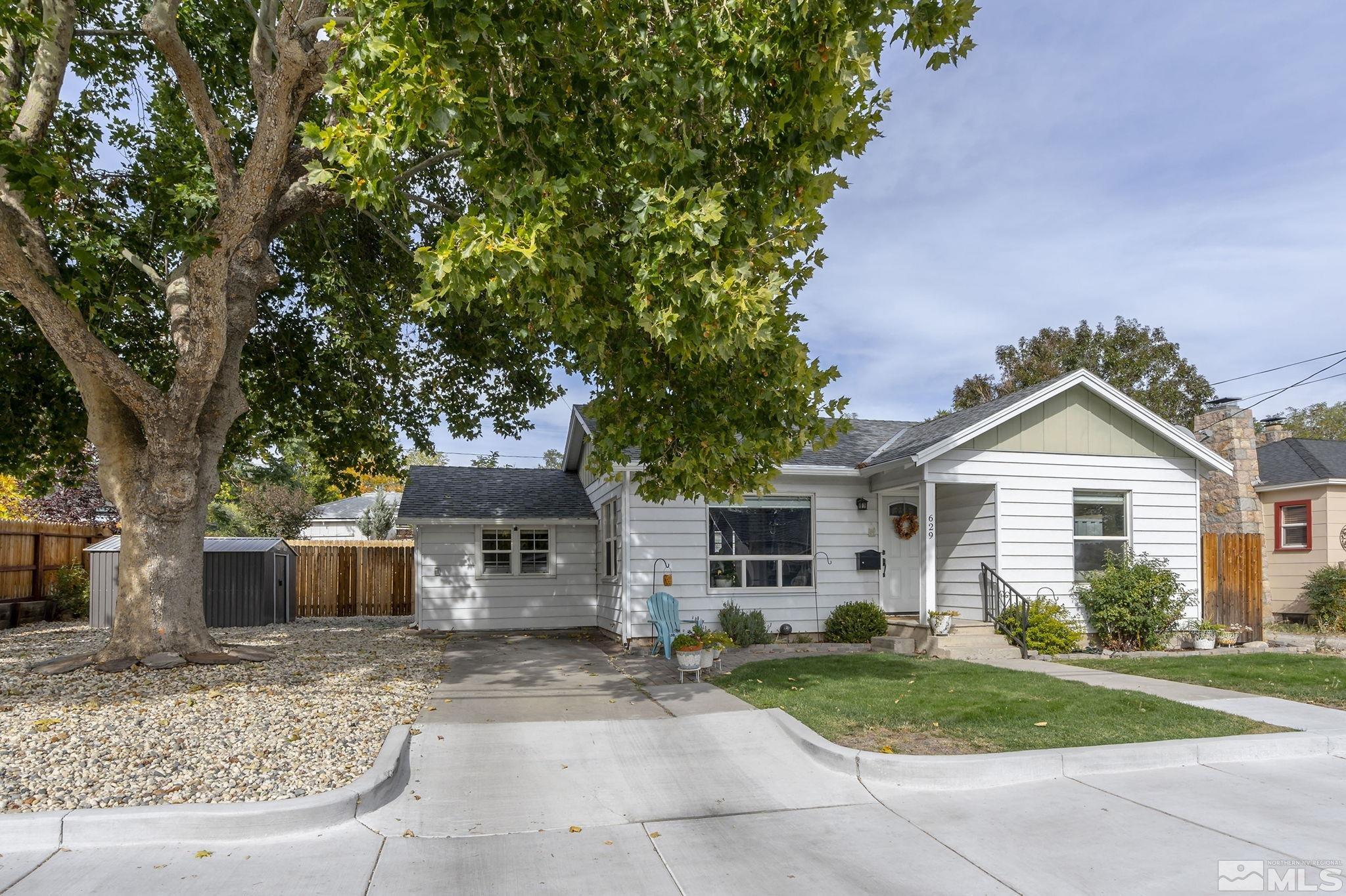 629 West 11th Street, Unit RENO Reno, NV 89503 - Photo 1 of 18 a front view of a house with a yard and a garage