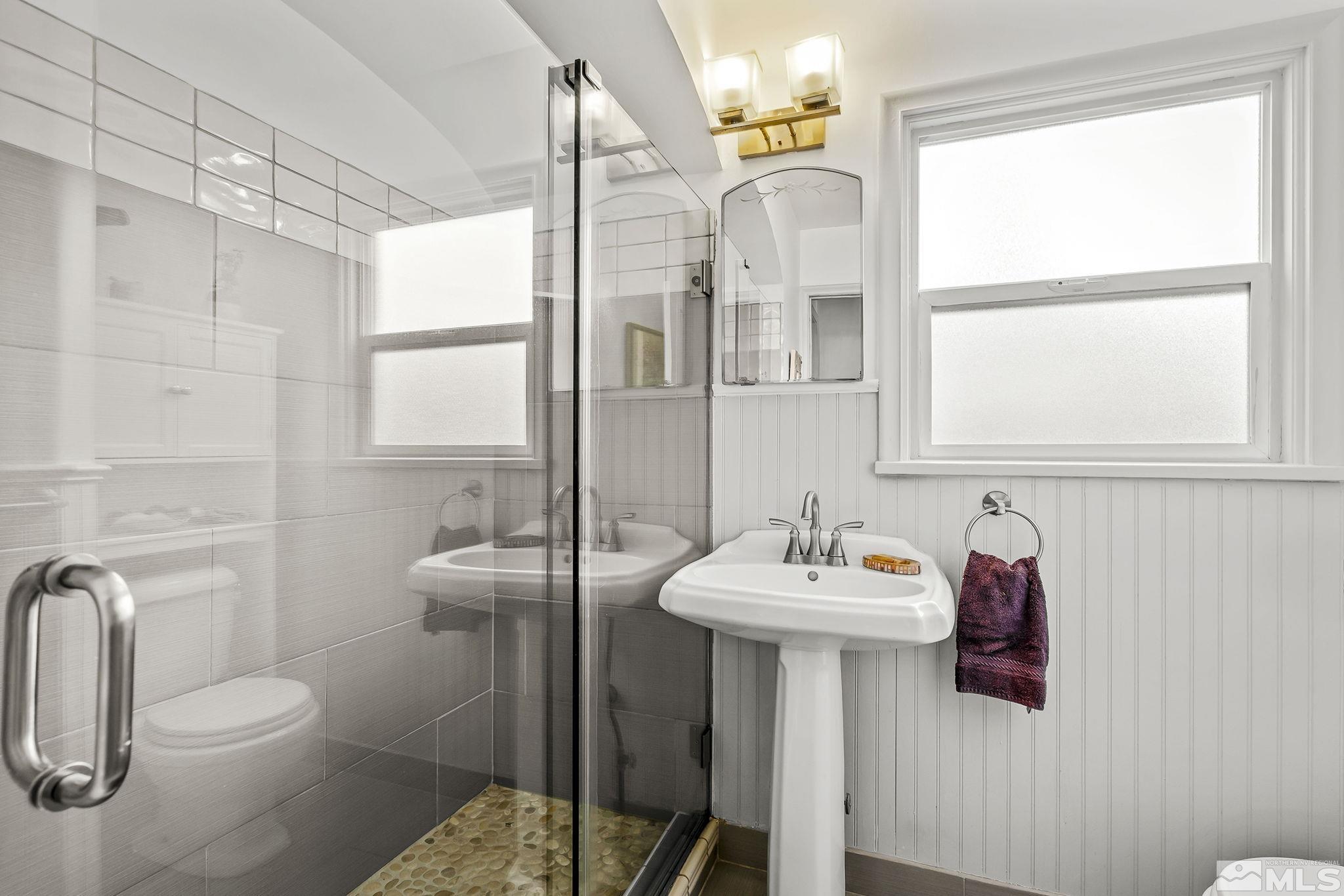 629 West 11th Street, Unit RENO Reno, NV 89503 - Photo 13 of 18 a bathroom with a sink toilet and mirror