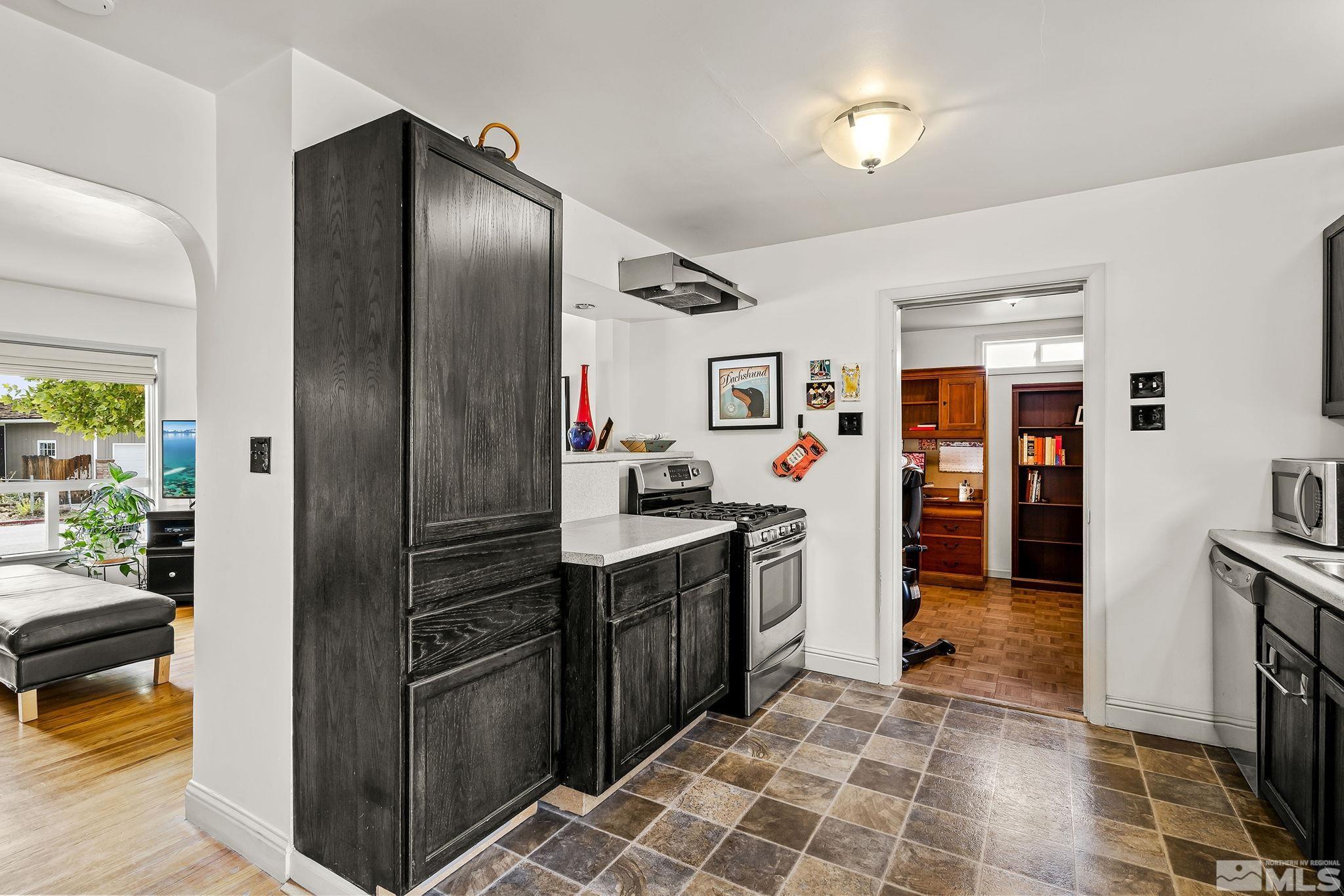 629 West 11th Street, Unit RENO Reno, NV 89503 - Photo 7 of 18 a kitchen with stainless steel appliances granite countertop a refrigerator and a stove
