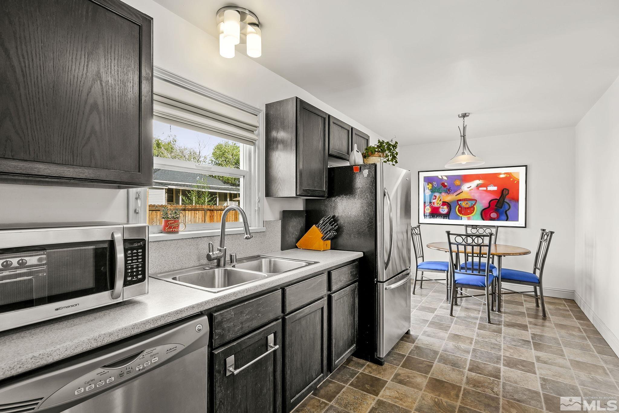 629 West 11th Street, Unit RENO Reno, NV 89503 - Photo 8 of 18 a kitchen with a sink cabinets and window