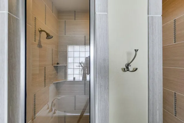a bathroom with a glass shower door