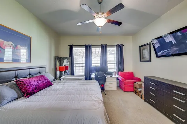 a bedroom with a bed dresser and a window