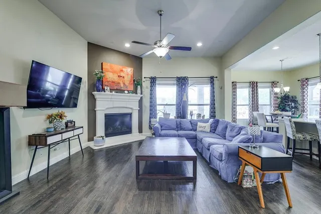 a living room with furniture a flat screen tv and a fireplace