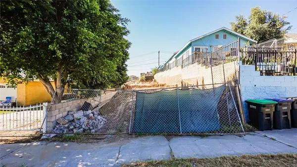 a view of a house with a wooden fence