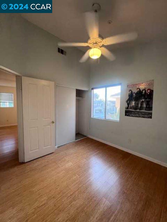 29160 Whitegate Lane Highland, CA 92346 - Photo 15 of 27 an empty room with wooden floor fan and windows
