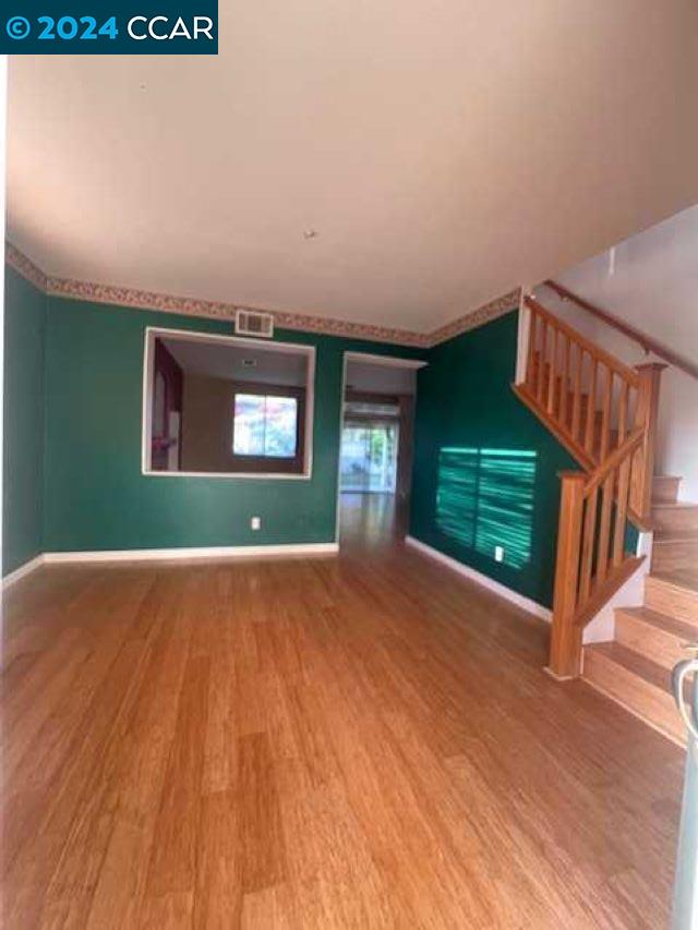 29160 Whitegate Lane Highland, CA 92346 - Photo 3 of 27 a view of an empty room with a window and fire place
