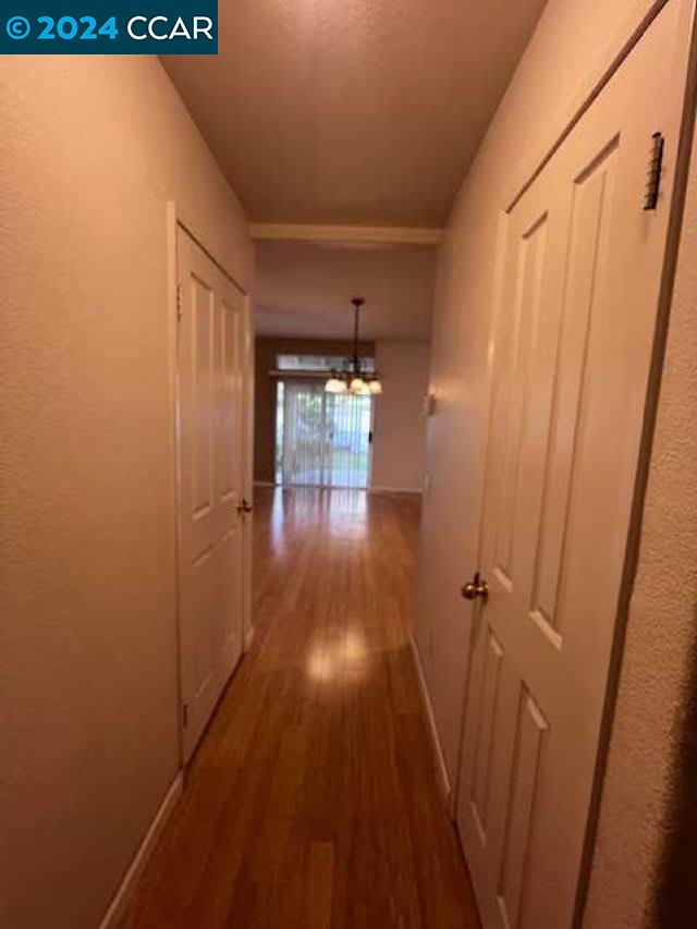 29160 Whitegate Lane Highland, CA 92346 - Photo 10 of 27 a hallway with wooden floor chandelier and entryway