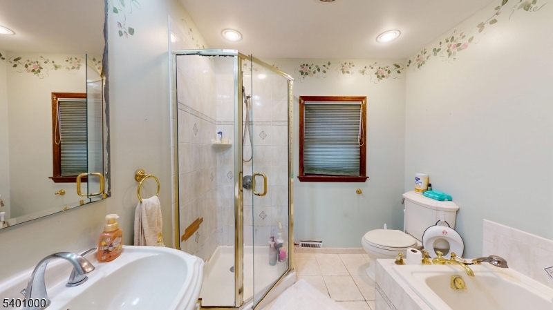 237 Winfield Terrace Union, NJ 07083 - Photo 12 of 21 a bathroom with a sink vanity granite tub and shower