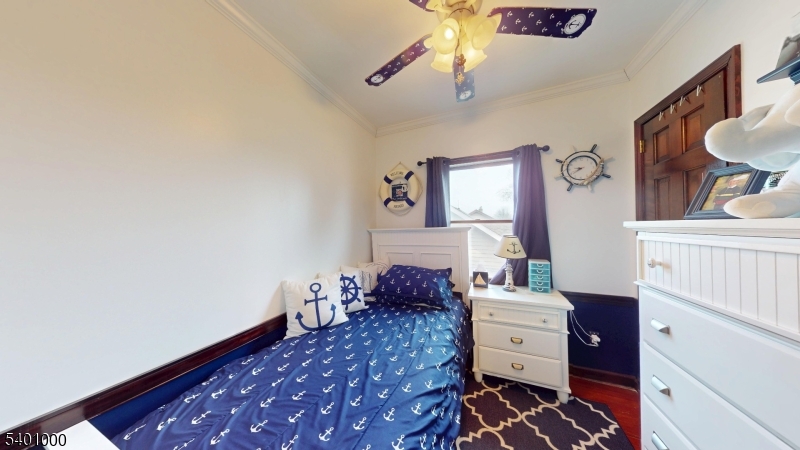 237 Winfield Terrace Union, NJ 07083 - Photo 17 of 21 a bedroom with a bed and a chandelier