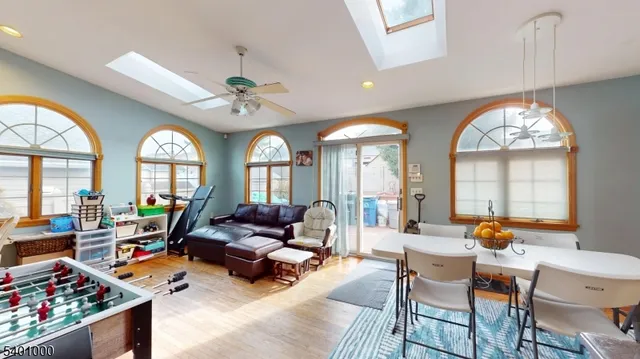 a living room with furniture a fireplace and a chandelier