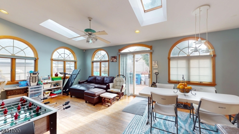 237 Winfield Terrace Union, NJ 07083 - Photo 7 of 21 a living room with furniture a fireplace and a chandelier