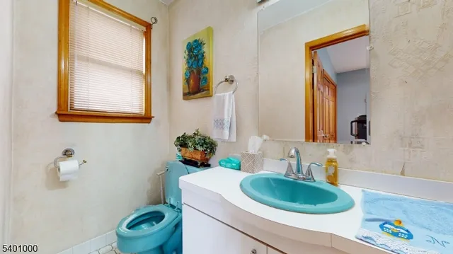 a bathroom with a sink a toilet and mirror