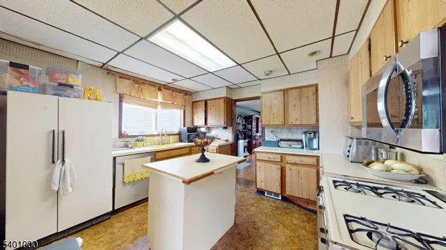 a kitchen with a sink a stove a refrigerator and cabinets