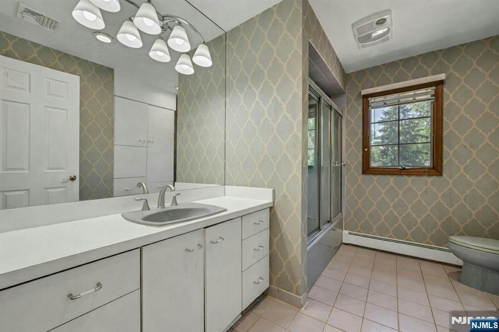 44 West Midland Avenue Paramus, NJ 07652 - Photo 15 of 19 a spacious bathroom with a granite countertop sink a large mirror and a shower