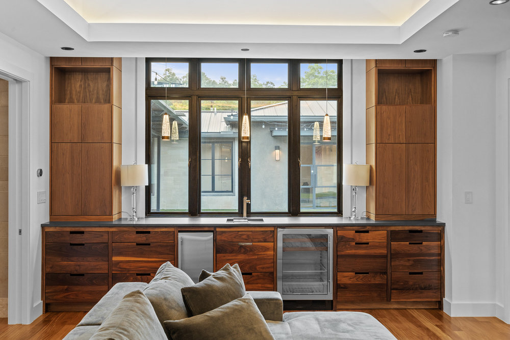 1905 Paisano Road Austin, TX 78746 - Photo 30 of 40 Custom cabinetry and built-in amenities define this refined entertainment space.