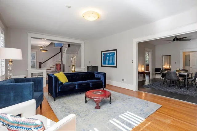 a living room with furniture and wooden floor
