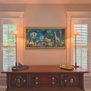 a view of a house with a yard and large tree