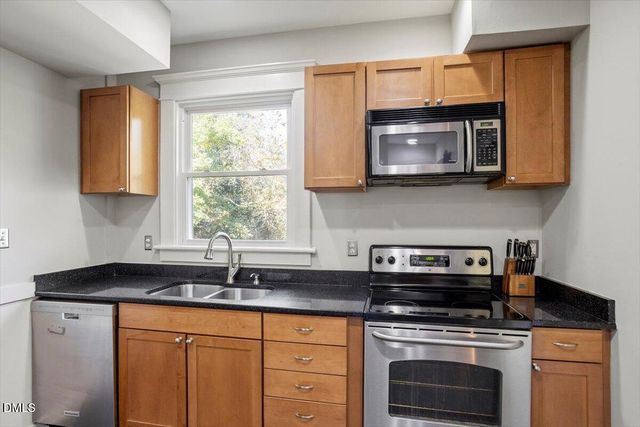 a living room with furniture kitchen view and a table