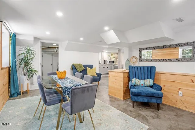 a dining room with furniture and wooden floor