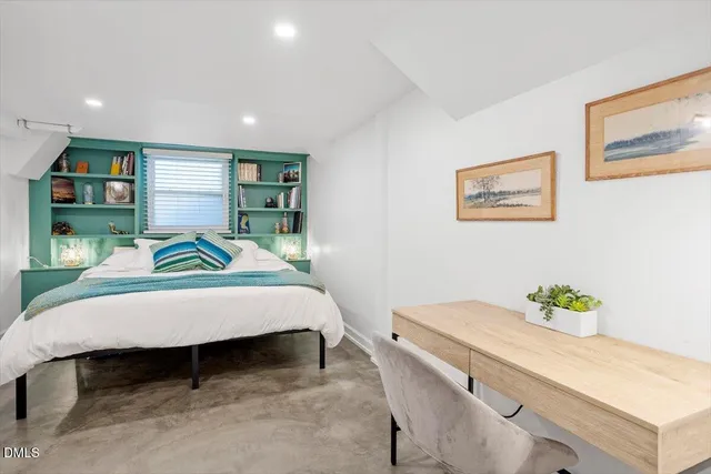 a bed room with furniture and a table