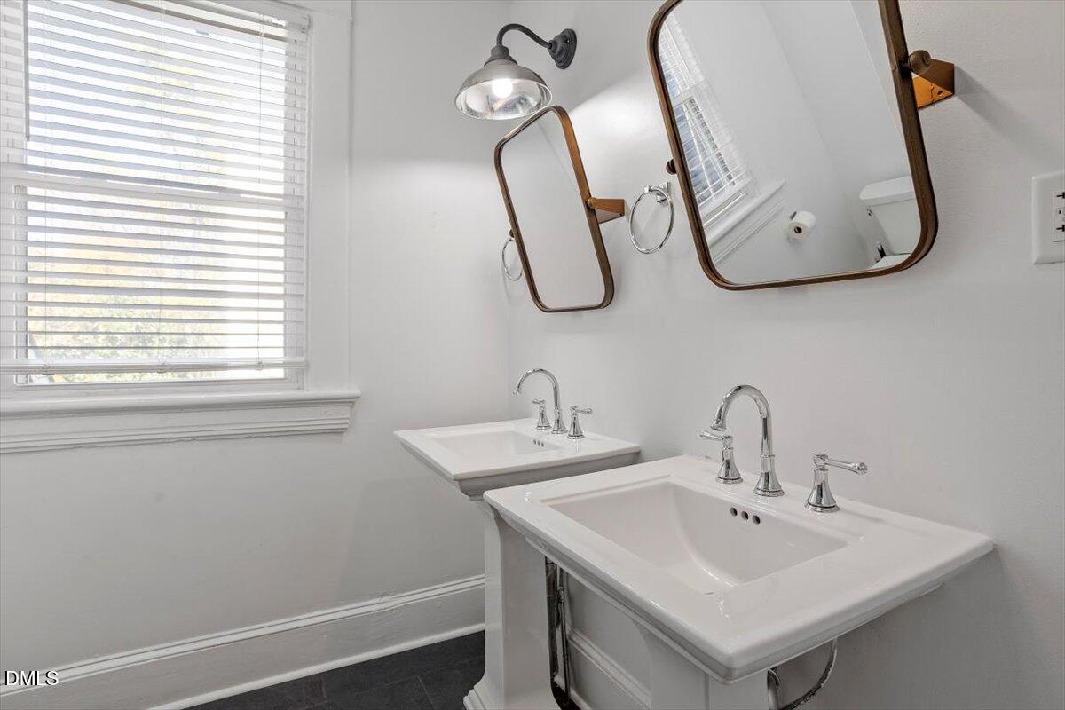 807 East Edenton Street Raleigh, NC 27601 - Photo 37 of 69 a bathroom with a sink and a mirror