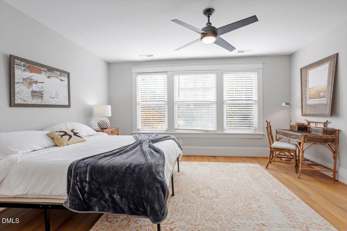807 East Edenton Street Raleigh, NC 27601 - Photo 38 of 69 a spacious bedroom with a bed a couch and a chandelier