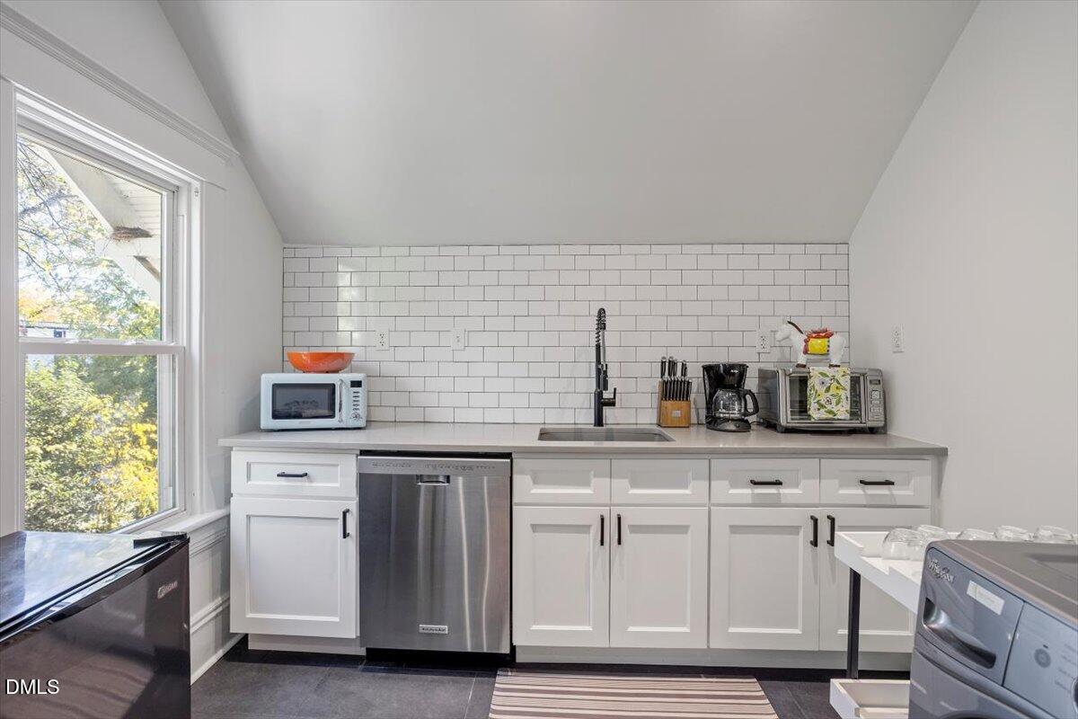 807 East Edenton Street Raleigh, NC 27601 - Photo 40 of 68 a kitchen with white cabinets and window