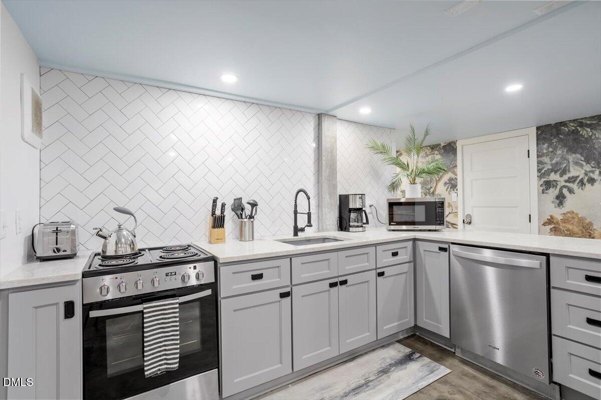 807 East Edenton Street Raleigh, NC 27601 - Photo 53 of 69 a kitchen with stainless steel appliances a sink and cabinets