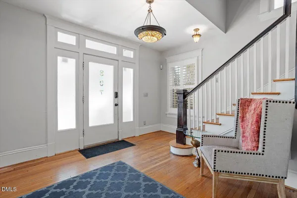 a living room with furniture and a chandelier