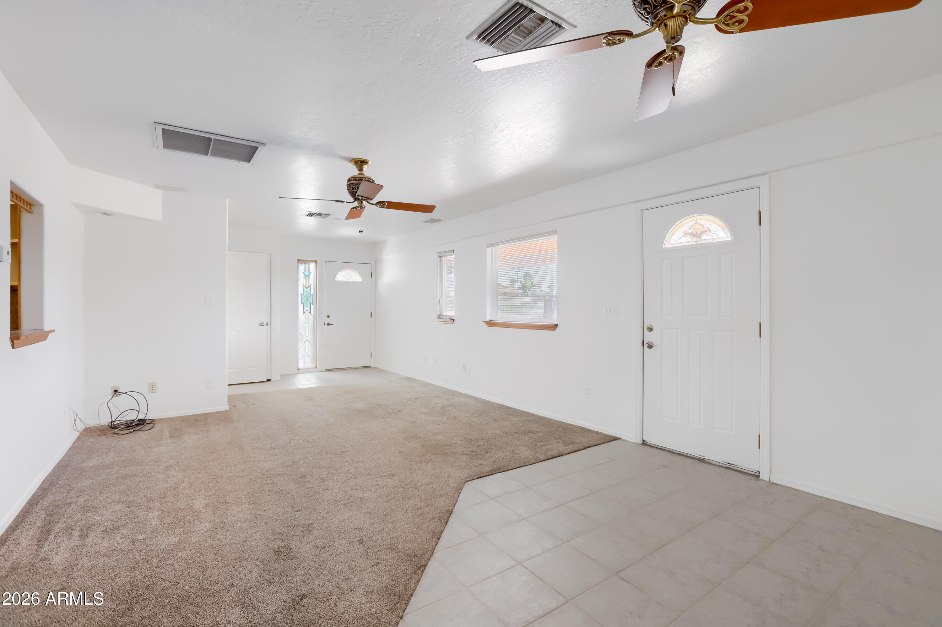 3823 West Greenway Road Phoenix, AZ 85053 - Photo 11 of 28 an empty room with a ceiling fan and a window