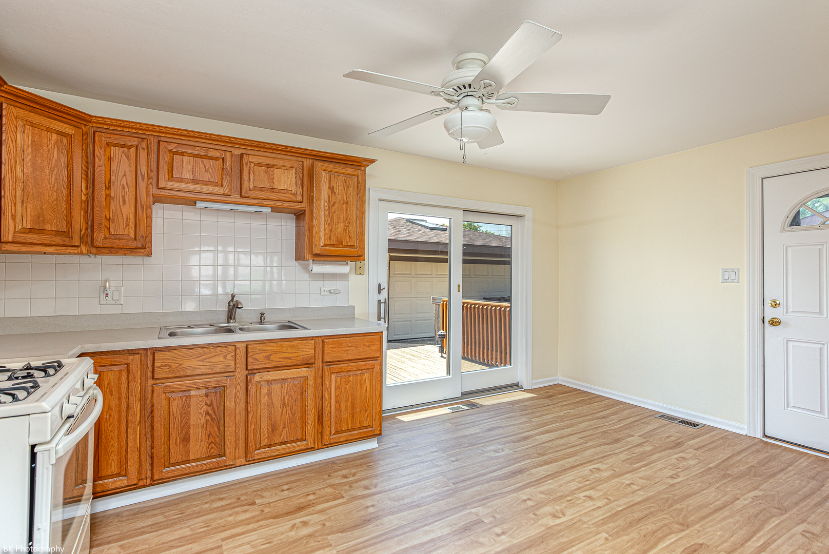 7049 West 91st Street Bridgeview, IL 60455 - Photo 6 of 25 a kitchen with stainless steel appliances granite countertop a sink cabinets and wooden floor