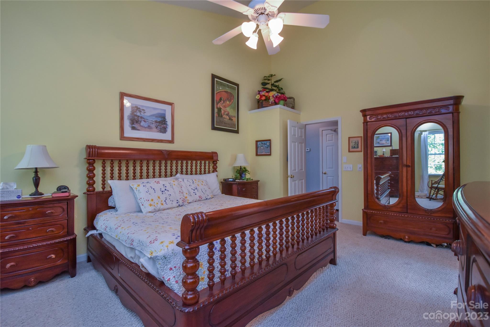 120 Comata Road Mooresville, NC 28117 - Photo 13 of 25 a bedroom with a bed and a chandelier
