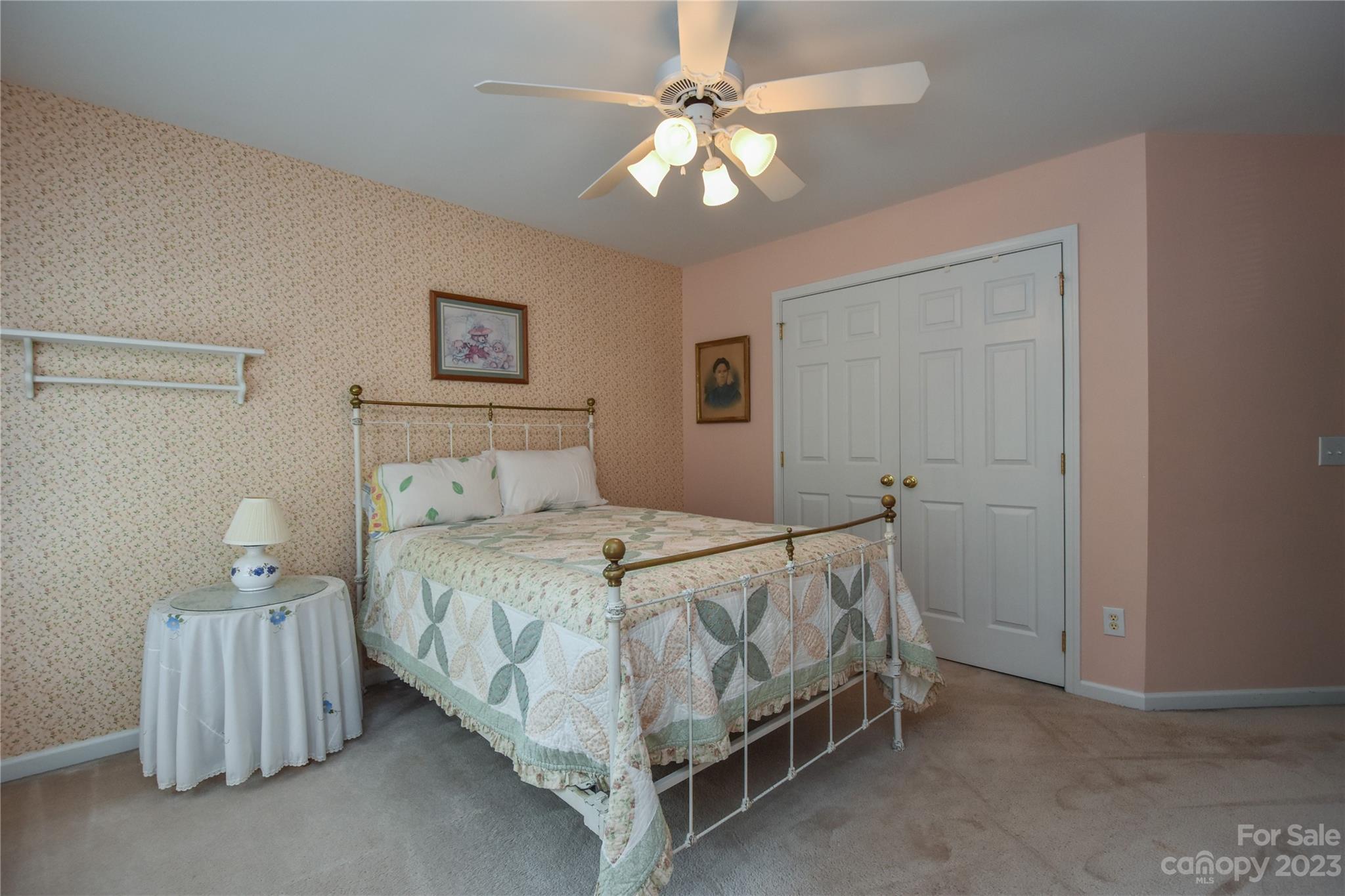 120 Comata Road Mooresville, NC 28117 - Photo 16 of 25 a bedroom with a bed and a ceiling fan