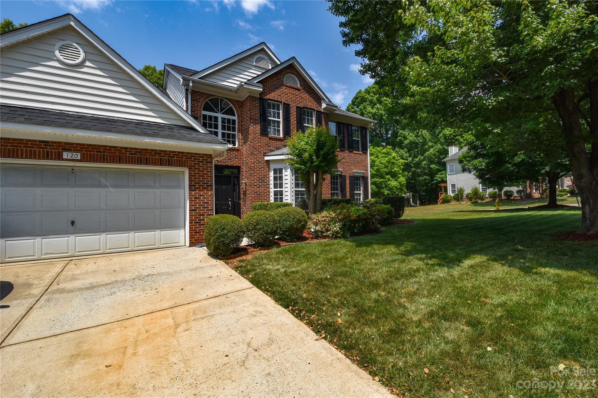 120 Comata Road Mooresville, NC 28117 - Photo 2 of 25 a front view of a house with a garden and trees