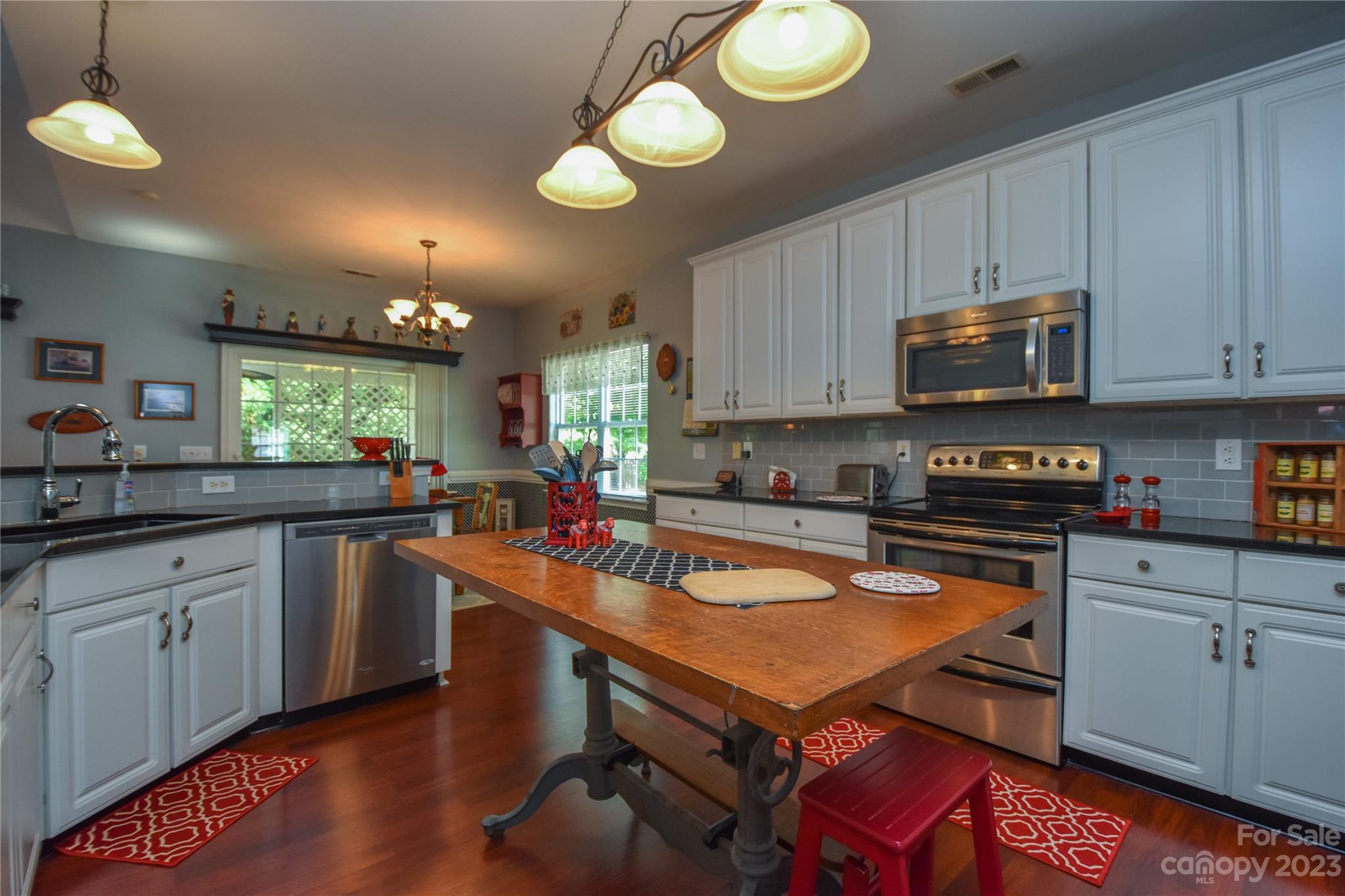 120 Comata Road Mooresville, NC 28117 - Photo 8 of 25 a kitchen with stainless steel appliances granite countertop a stove a sink dishwasher and a microwave with wooden cabinets