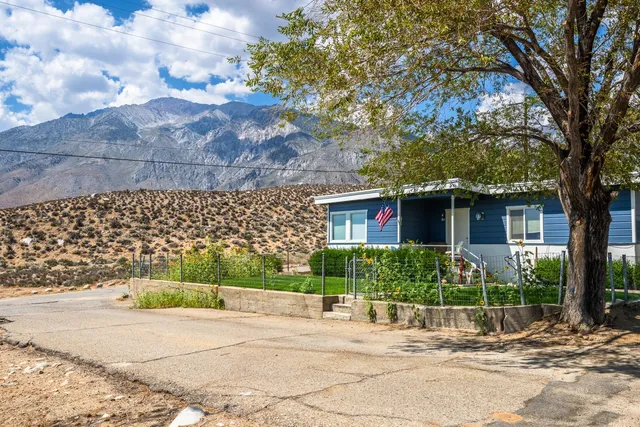 a view of a yard with wooden fence