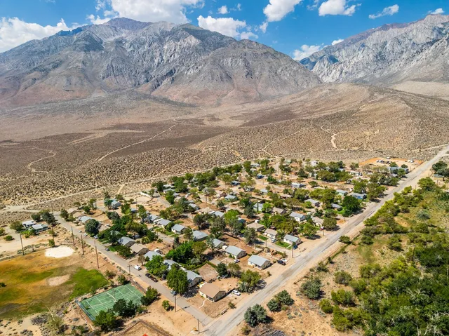 an aerial view of residential houses with outdoor space