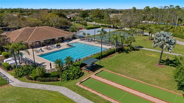an aerial view of residential houses with outdoor space and trees
