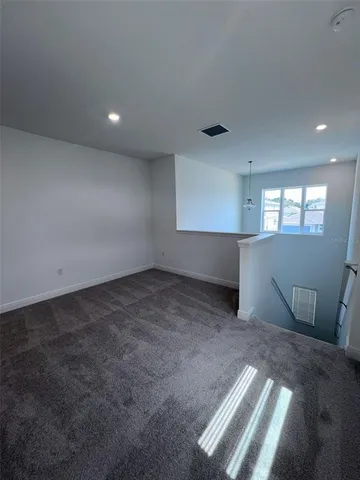 an empty room with a empty space and windows