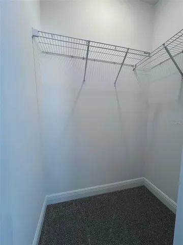 a bathroom with a toilet sink double vanity and mirror