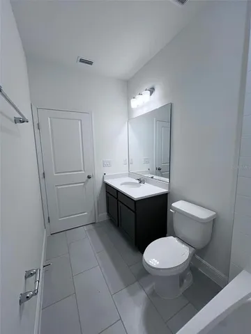 a view of a house with a yard and potted plants