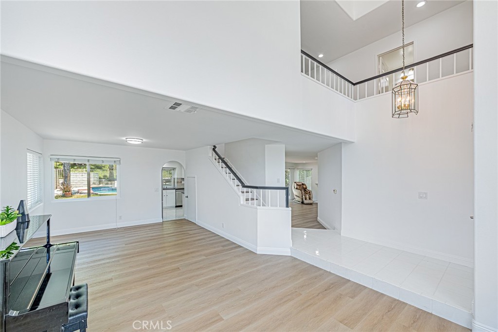 25533 Longfellow Place Stevenson Ranch, CA 91381 - Photo 5 of 47 a view of empty room with wooden floor and fan