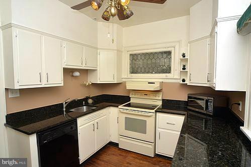 2311 Forest Glen Road Silver Spring, MD 20910 - Photo 13 of 28 a kitchen with a sink stove and cabinets