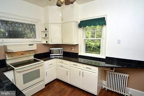 2311 Forest Glen Road Silver Spring, MD 20910 - Photo 14 of 28 a kitchen with granite countertop white cabinets and white appliances