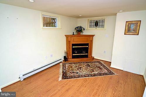 2311 Forest Glen Road Silver Spring, MD 20910 - Photo 16 of 28 a living room with a fireplace and a rug